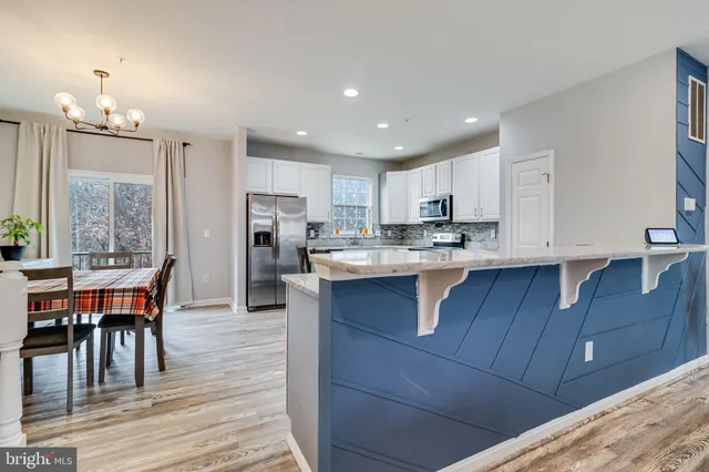 a kitchen with wooden cabinets and refrigerator