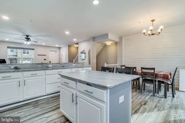 a kitchen with a sink dining table and chairs