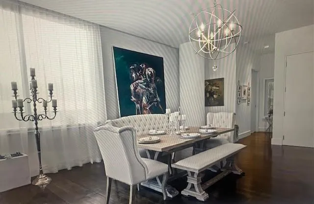 a view of a dining room with furniture wooden floor and chandelier