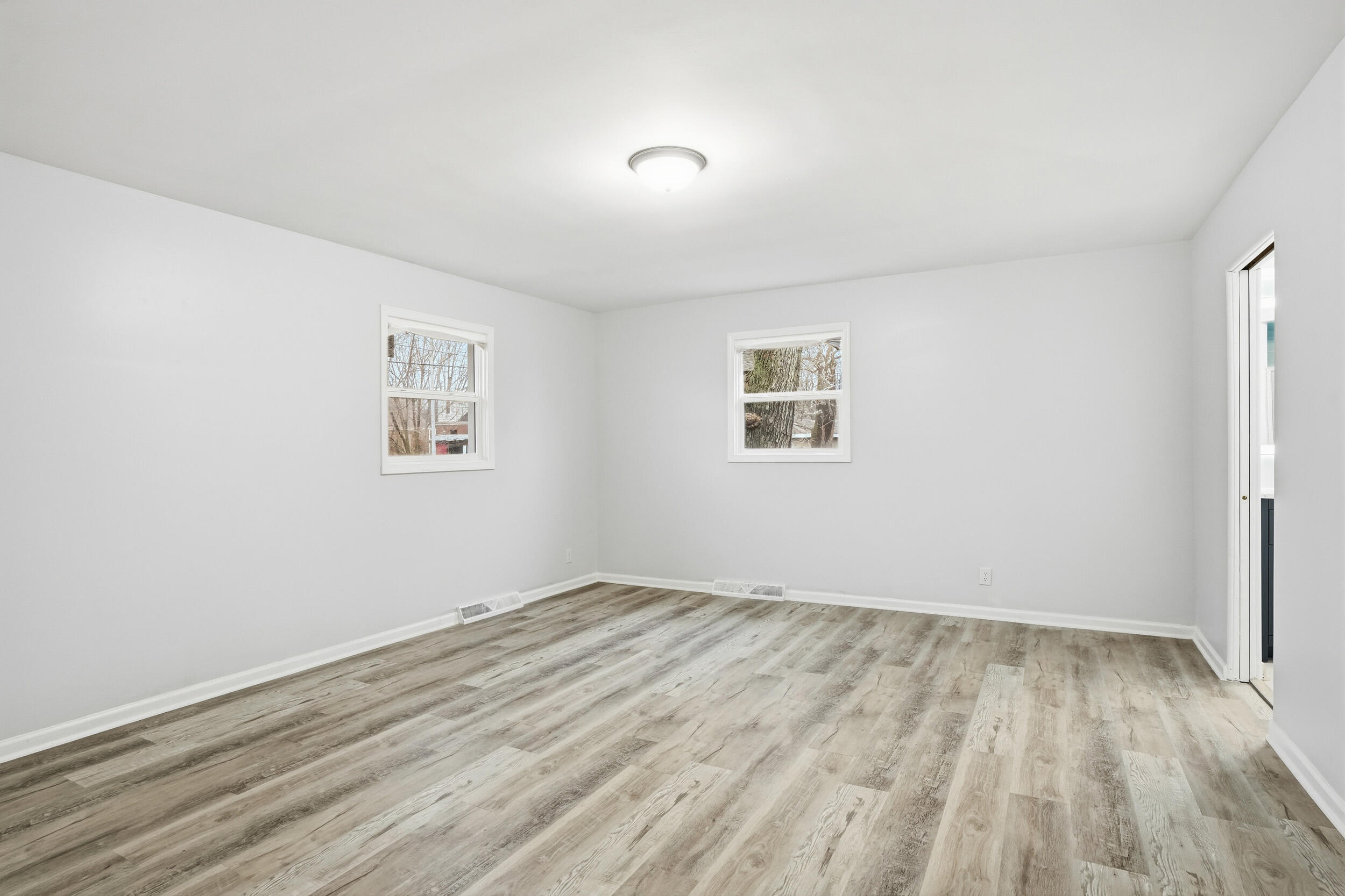 4800 Adams Street Gary, IN 46408 - Photo 12 of 24 an empty room with wooden floor and windows