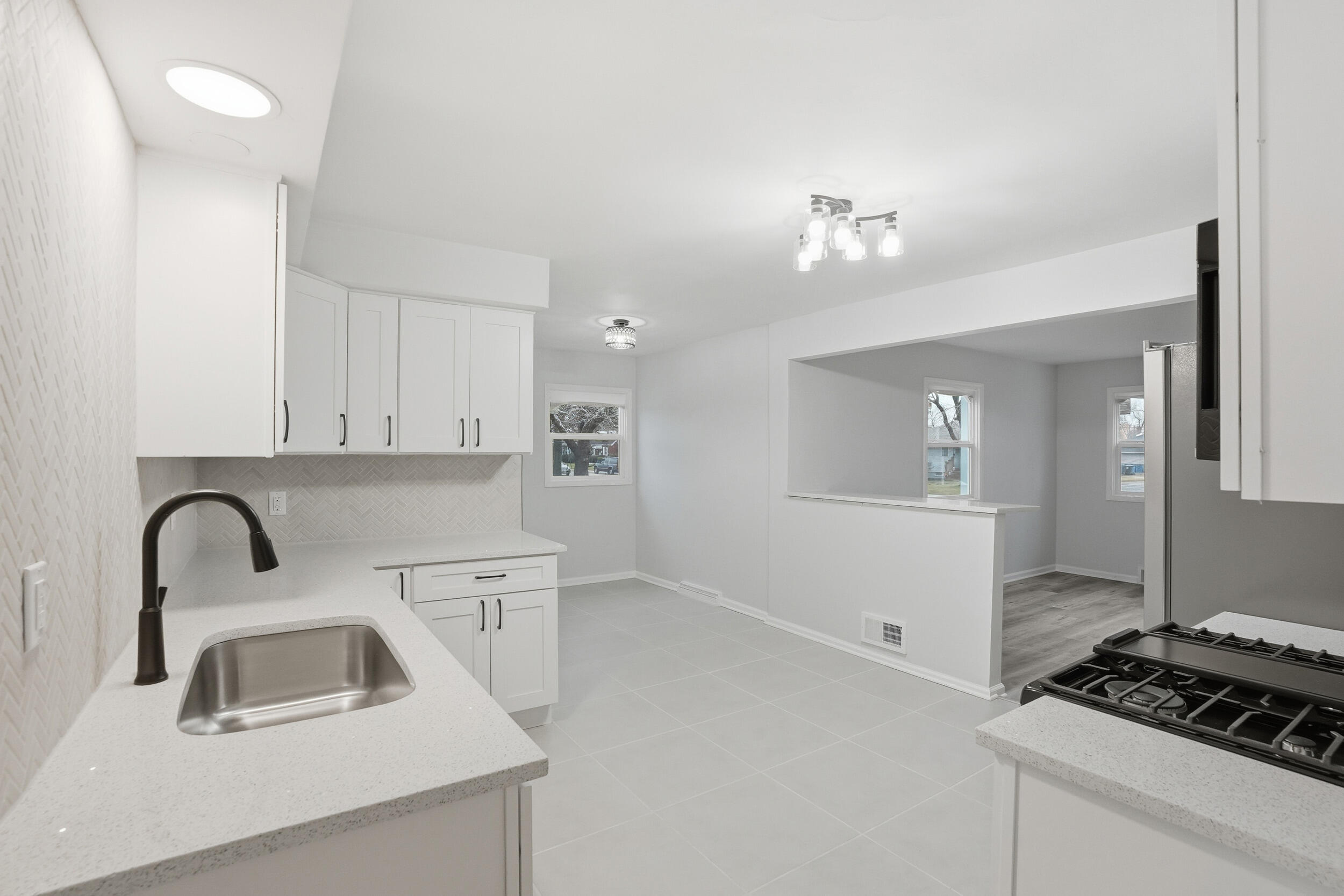 4800 Adams Street Gary, IN 46408 - Photo 4 of 24 a kitchen with sink a stove and cabinets