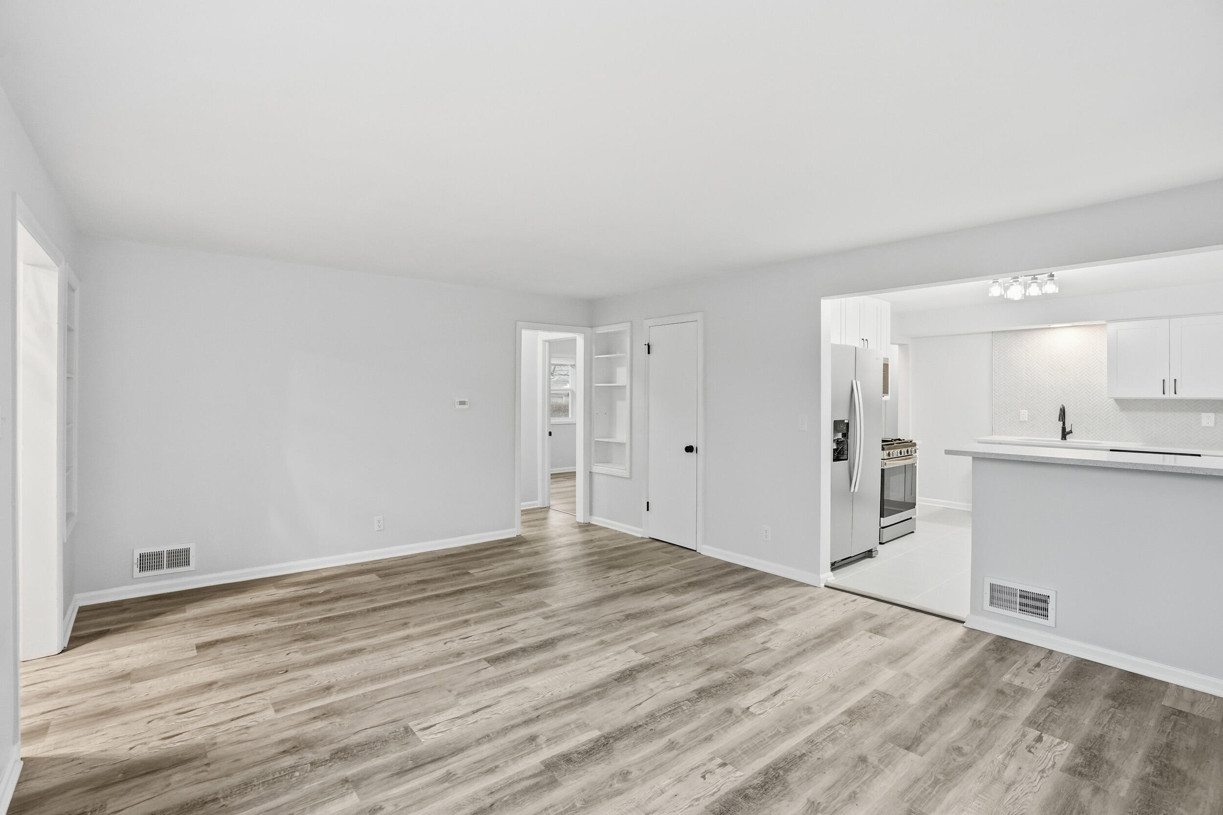 4800 Adams Street Gary, IN 46408 - Photo 6 of 24 a view of an empty room with wooden floor and a window
