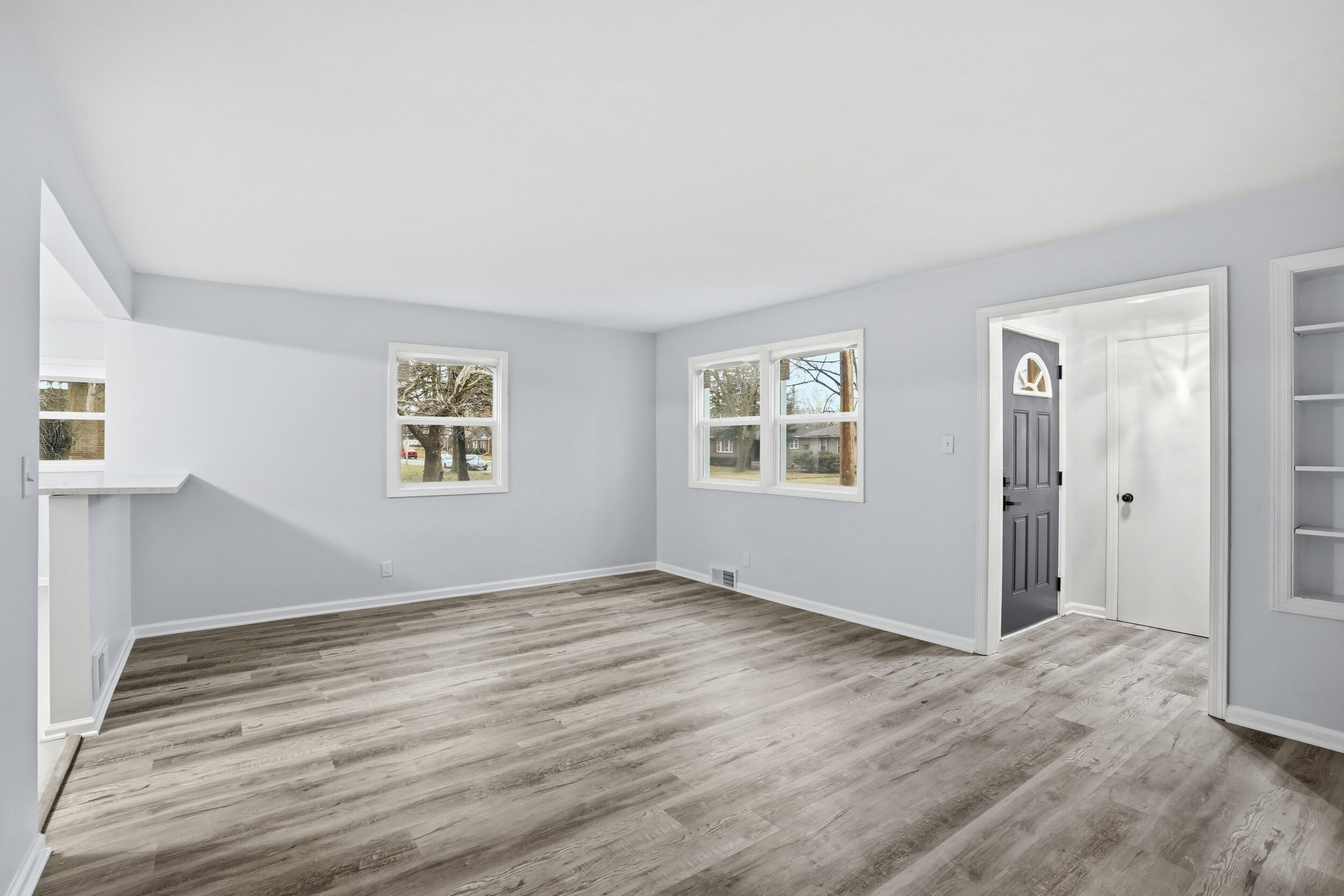 4800 Adams Street Gary, IN 46408 - Photo 9 of 24 a view of an empty room with wooden floor and a window