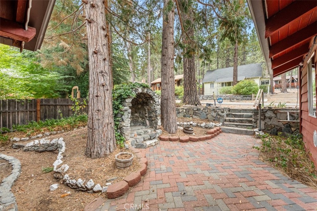 1056 Lark Road Wrightwood, CA 92397 - Photo 3 of 40 a view of a backyard with large trees and plants