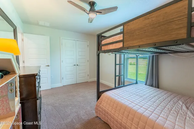 a bedroom with a bed dresser and a window