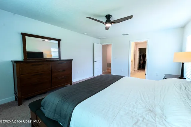 a bedroom with a bed and a dresser