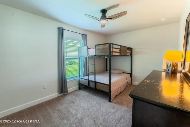 a bedroom with bed and a window