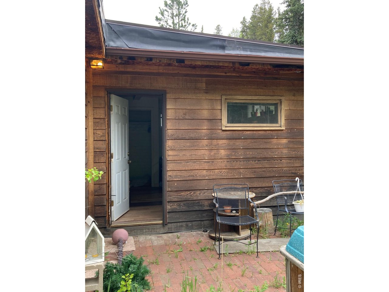 1064 Cold Springs Road Nederland, CO 80466 - Photo 22 of 48 a view of backyard with a chair and table