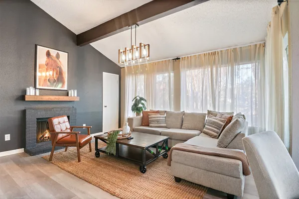 a living room with furniture and a chandelier