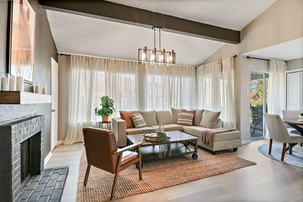 a living room with furniture dining table and a fireplace