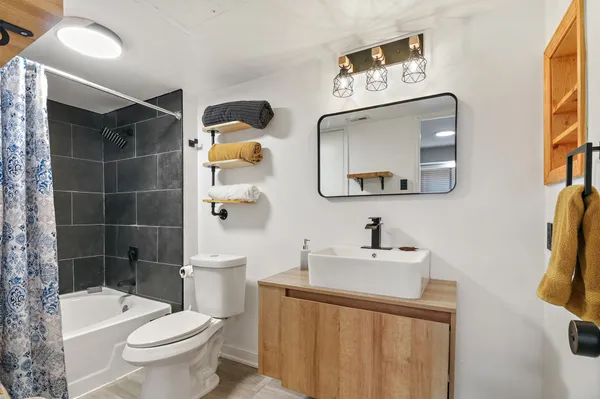 a bathroom with a sink toilet and shower