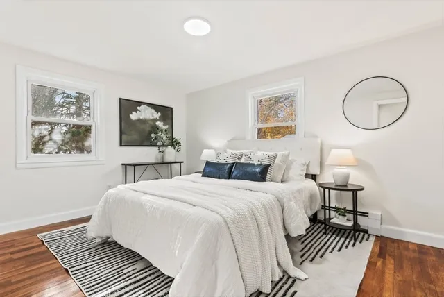 a bedroom with a large bed and a window