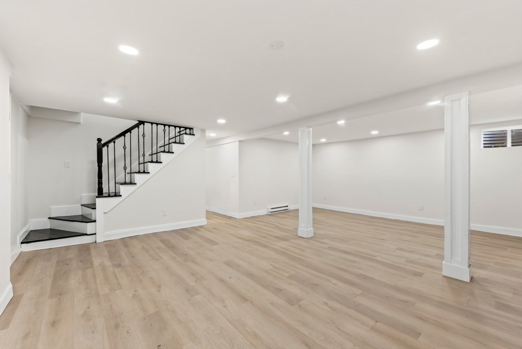 1156 Washington Street Walpole, MA 02081 - Photo 16 of 26 a view of an empty room with wooden floor and stairs