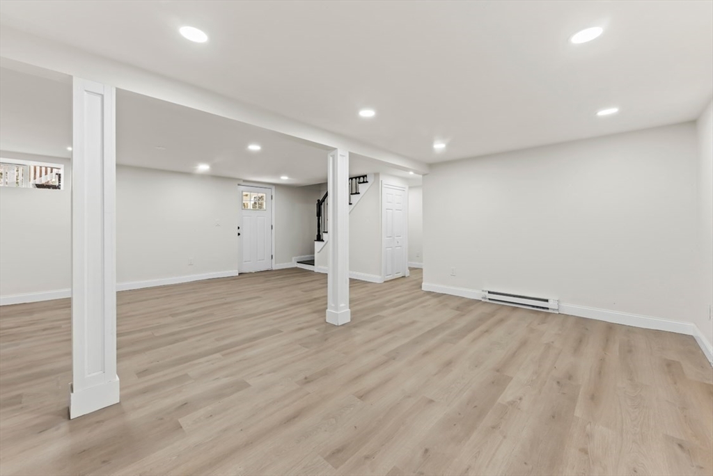 1156 Washington Street Walpole, MA 02081 - Photo 17 of 26 an empty room with wooden floor and white walls