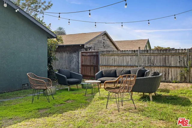 a roof deck with a table and chairs