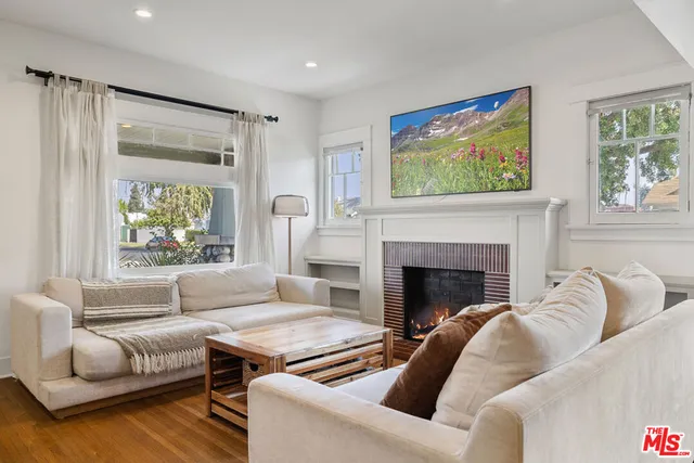 a living room with furniture fireplace and window