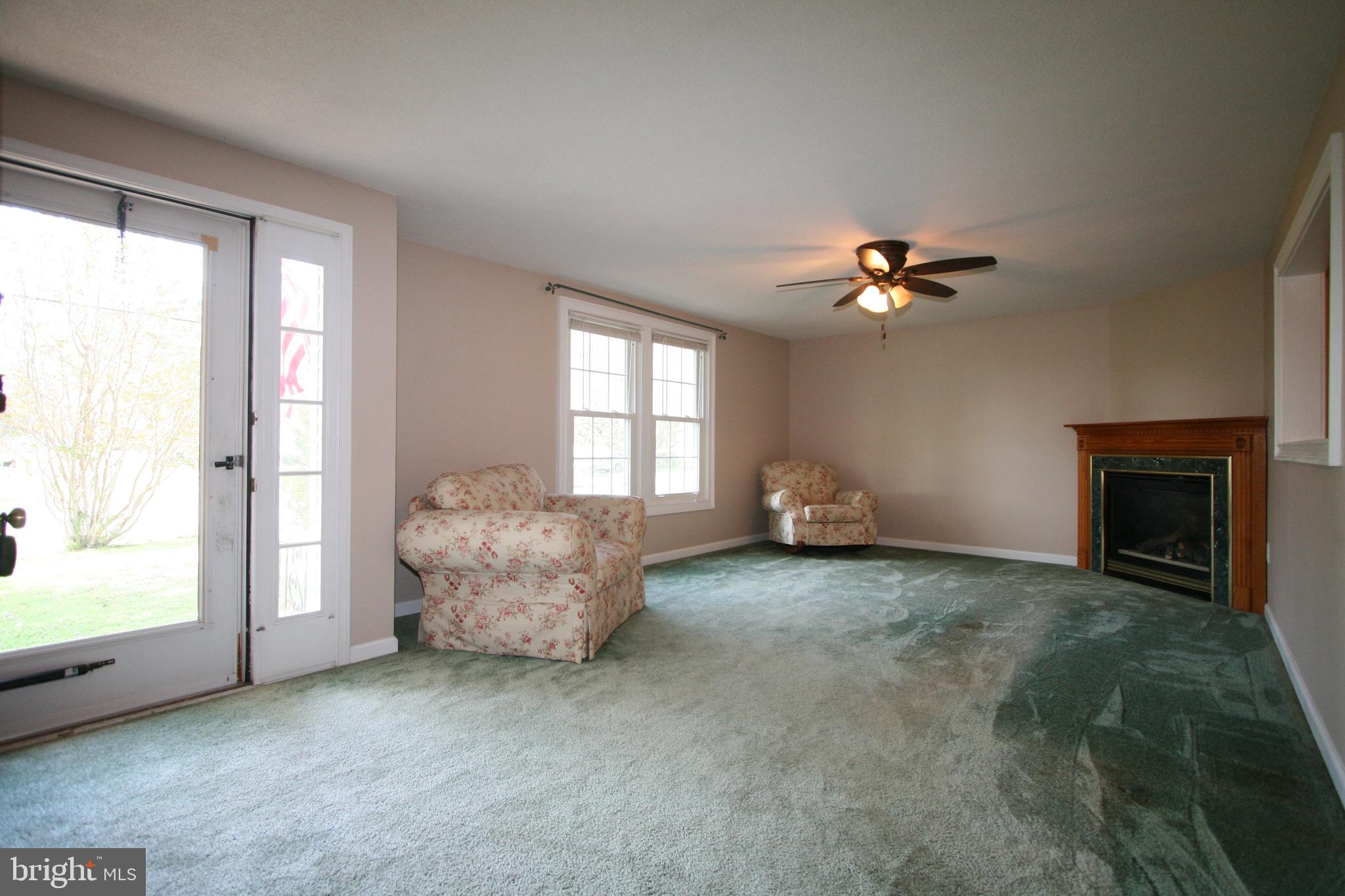 1305 Garrett Road Chester, MD 21619 - Photo 22 of 54 Living room with ceiling fan and gas fireplace!