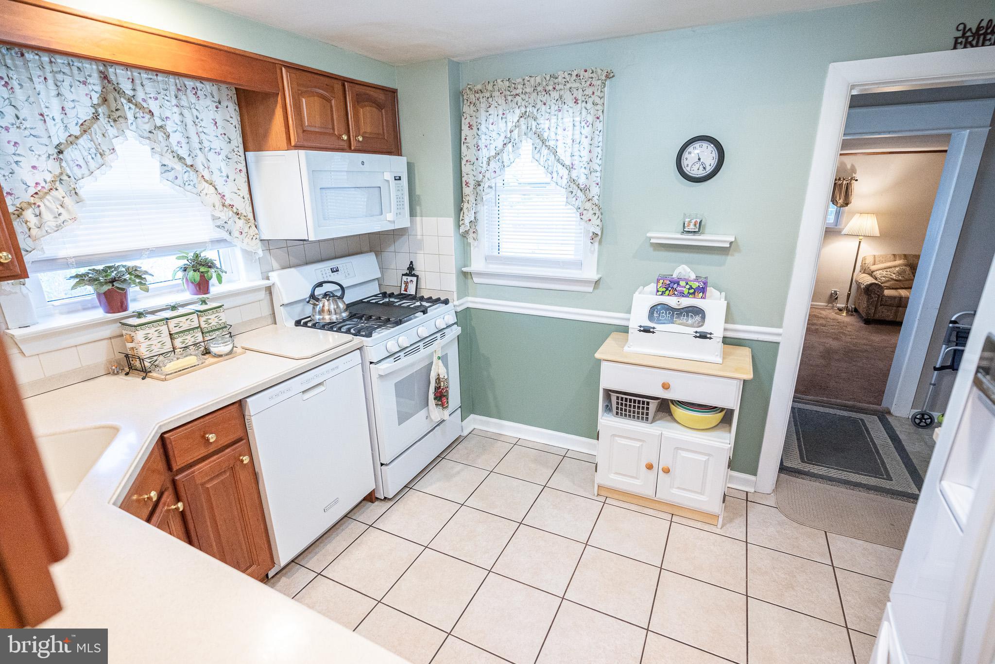 320 Valley View Road Media, PA 19063 - Photo 11 of 34 a kitchen with a stove a sink cabinets and a window