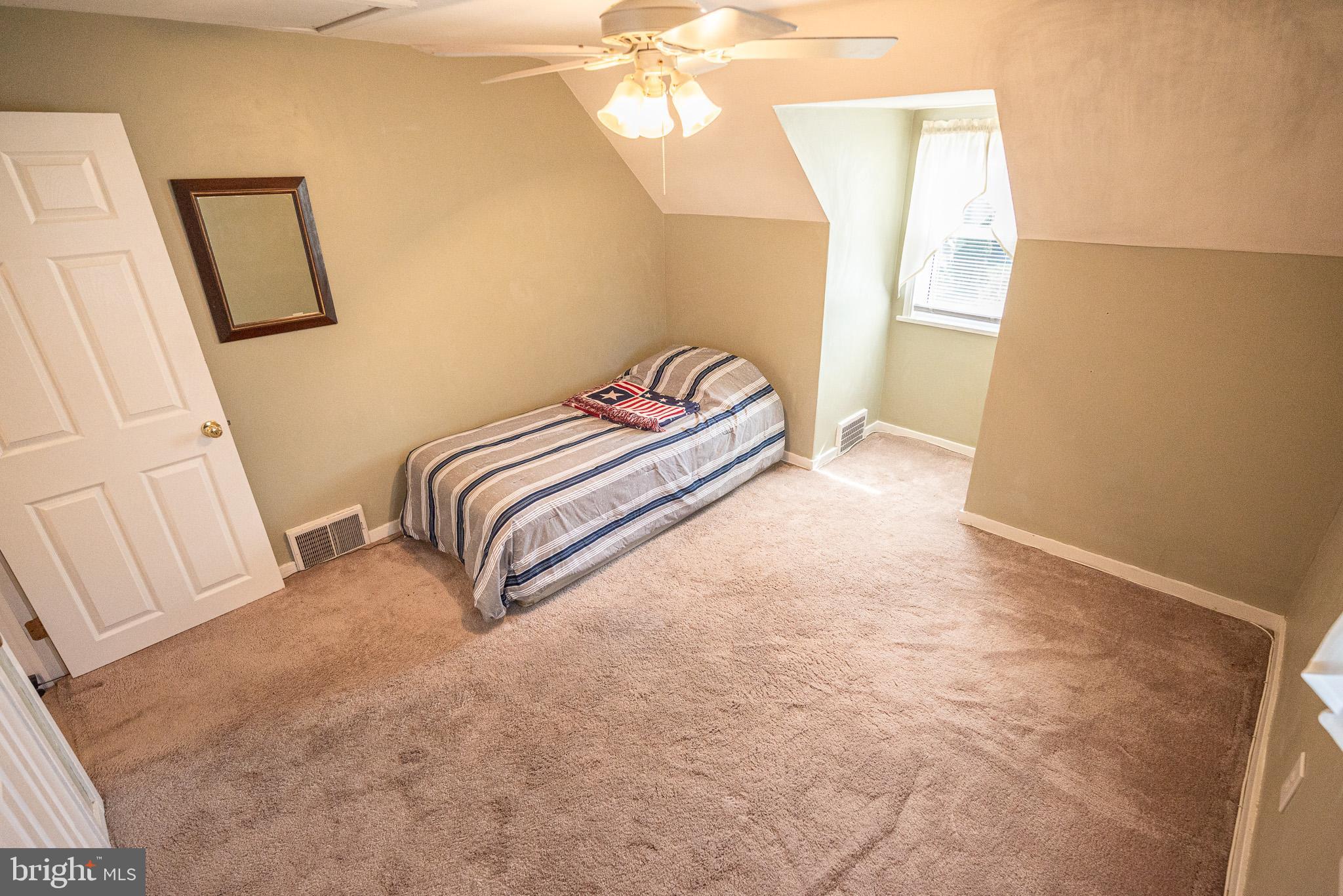 320 Valley View Road Media, PA 19063 - Photo 27 of 34 a spacious bedroom with a bed and a window