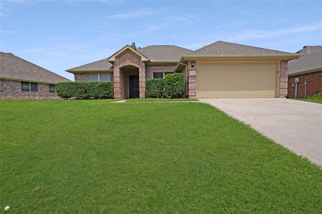 2910 Chisholm Trail Corinth, TX 76210 - Photo 30 of 30 a front view of a house with a garden