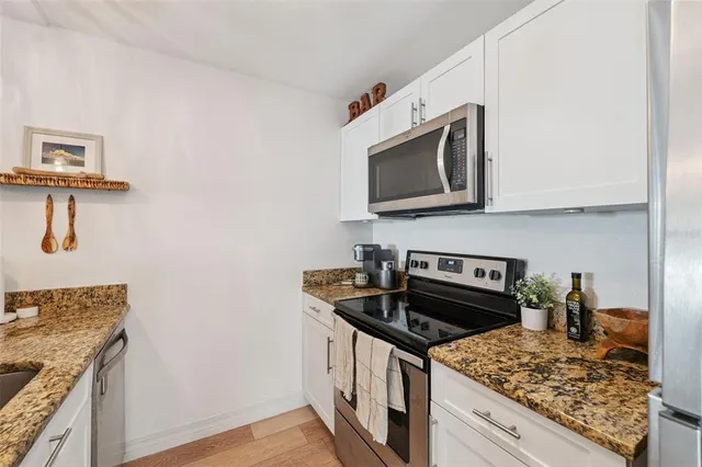 a kitchen with a sink stove and refrigerator