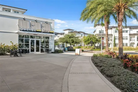 an aerial view of residential houses with outdoor space and ocean view