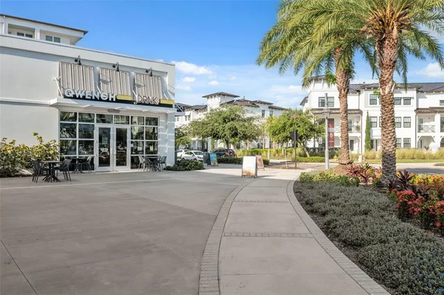 an aerial view of residential houses with outdoor space and ocean view