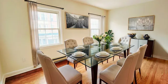 a view of a dining room with furniture window and wooden floor