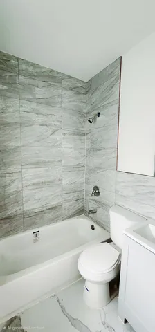 a bathroom with a toilet and a bathtub