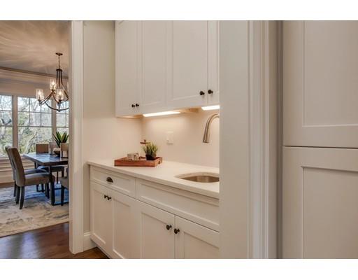 21 Fairhaven Road Newton, MA 02459 - Photo 15 of 30 a kitchen with a white cabinets and wooden floor