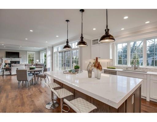 21 Fairhaven Road Newton, MA 02459 - Photo 16 of 30 a kitchen with stainless steel appliances granite countertop a stove a kitchen island a dining table and chairs