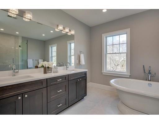 21 Fairhaven Road Newton, MA 02459 - Photo 26 of 30 a bathroom with a granite countertop double vanity sink a mirror and a bathtub