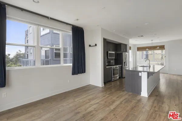 a kitchen with kitchen island a stove a sink and a refrigerator