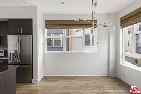 a view of a room with a window and wooden floor