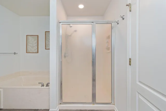 a bathroom with a shower and a bath tub