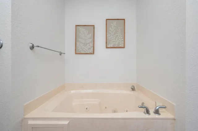 a white bath tub and a shower