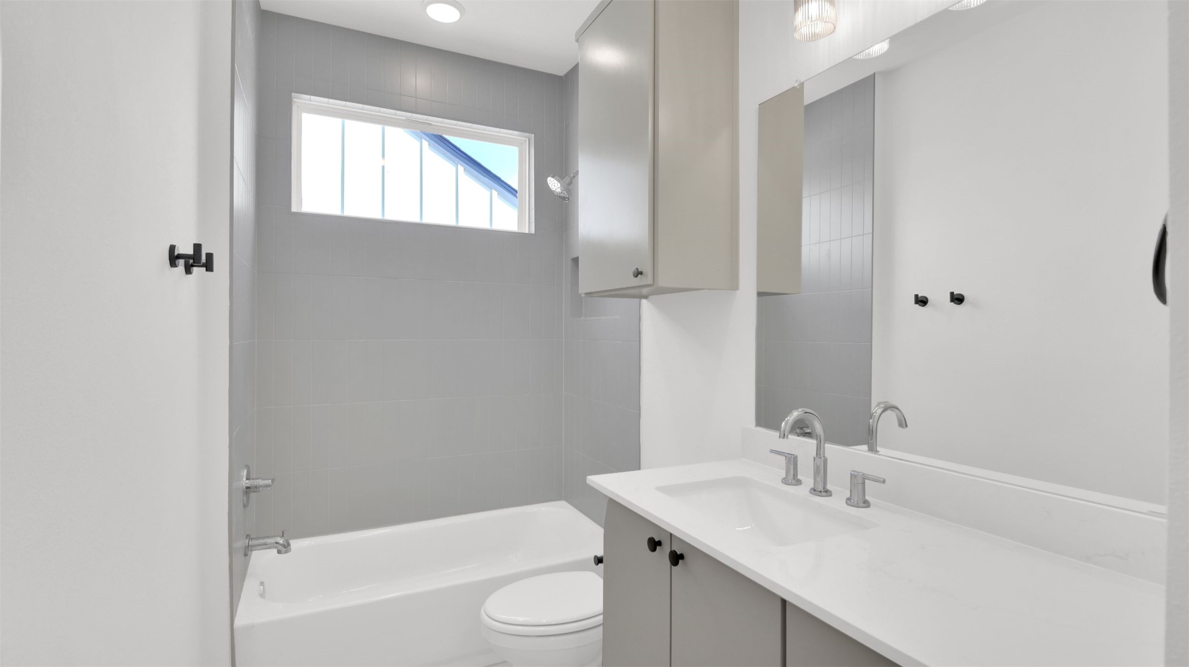 7208 Providence Avenue, Unit 2 Austin, TX 78752 - Photo 15 of 19 a bathroom with a sink toilet vanity and tub