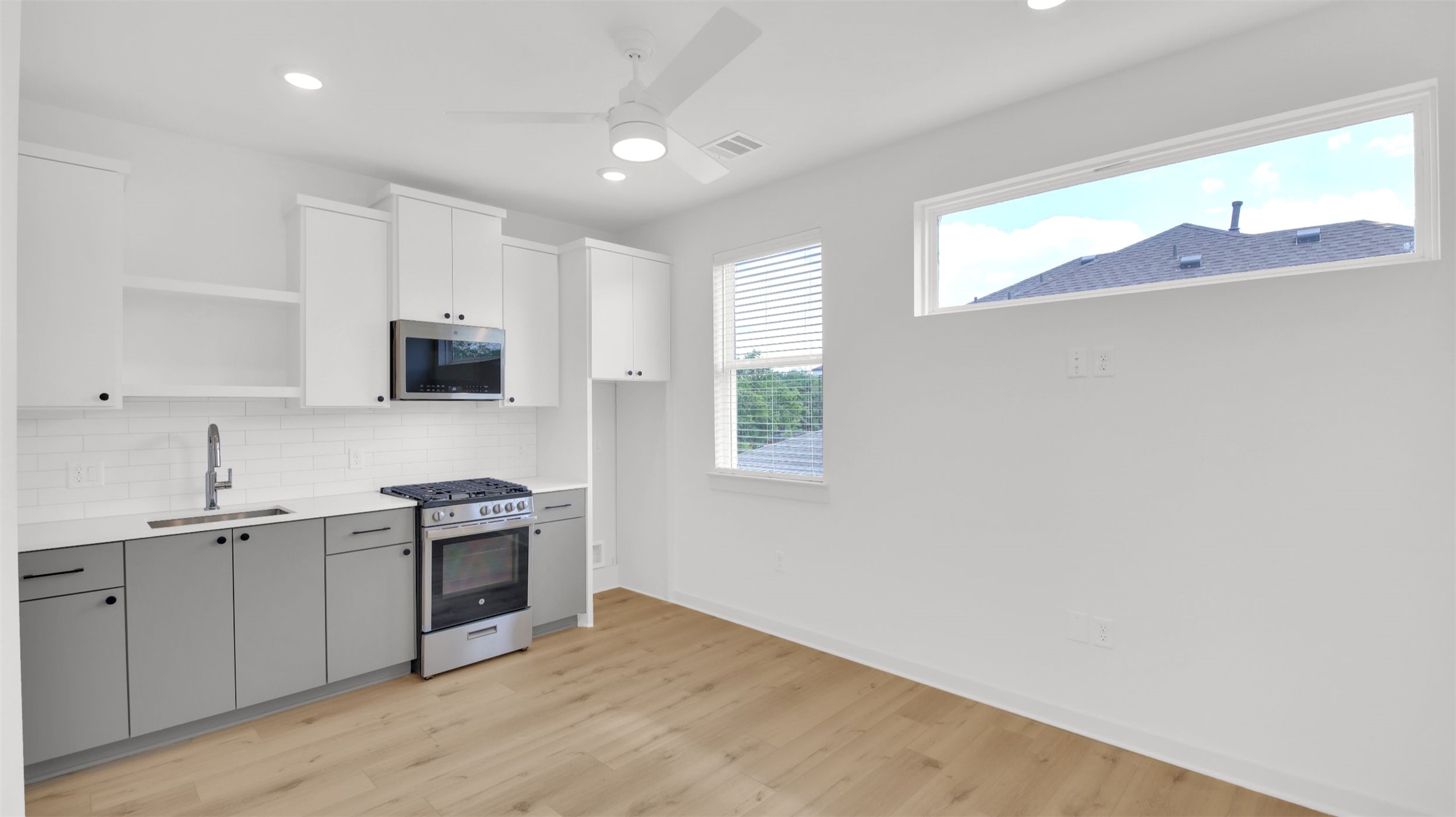 7208 Providence Avenue, Unit 2 Austin, TX 78752 - Photo 5 of 19 a kitchen with stainless steel appliances granite countertop a sink and a stove top oven