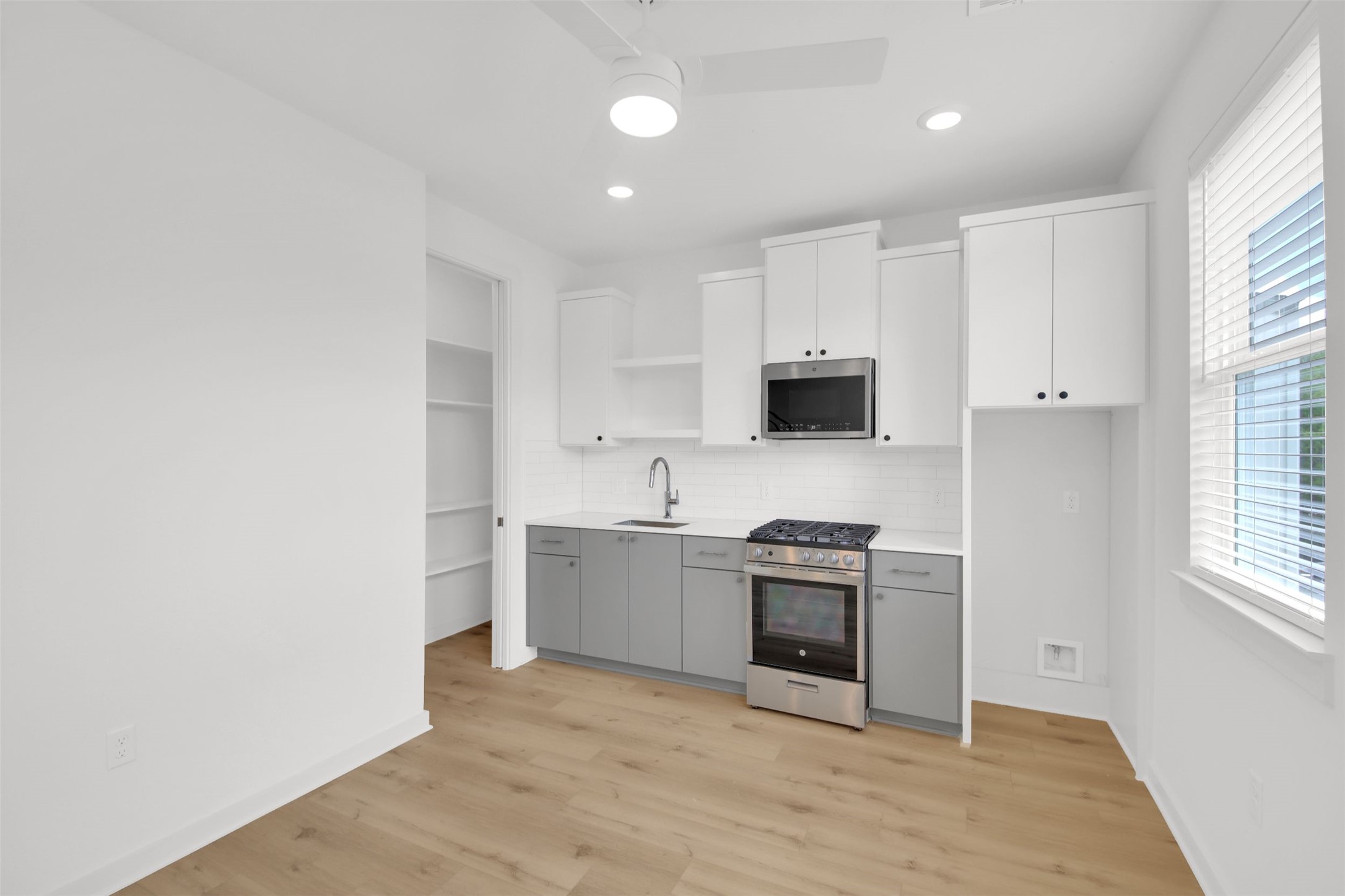 7208 Providence Avenue, Unit 2 Austin, TX 78752 - Photo 7 of 19 a kitchen with stainless steel appliances granite countertop a stove a sink and a microwave