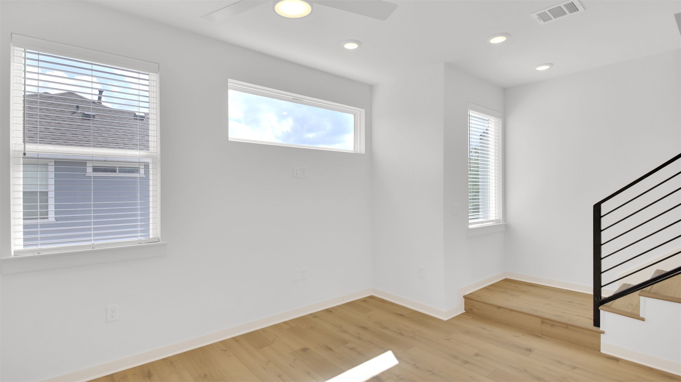 7208 Providence Avenue, Unit 2 Austin, TX 78752 - Photo 9 of 19 a view of an empty room with wooden floor and a window
