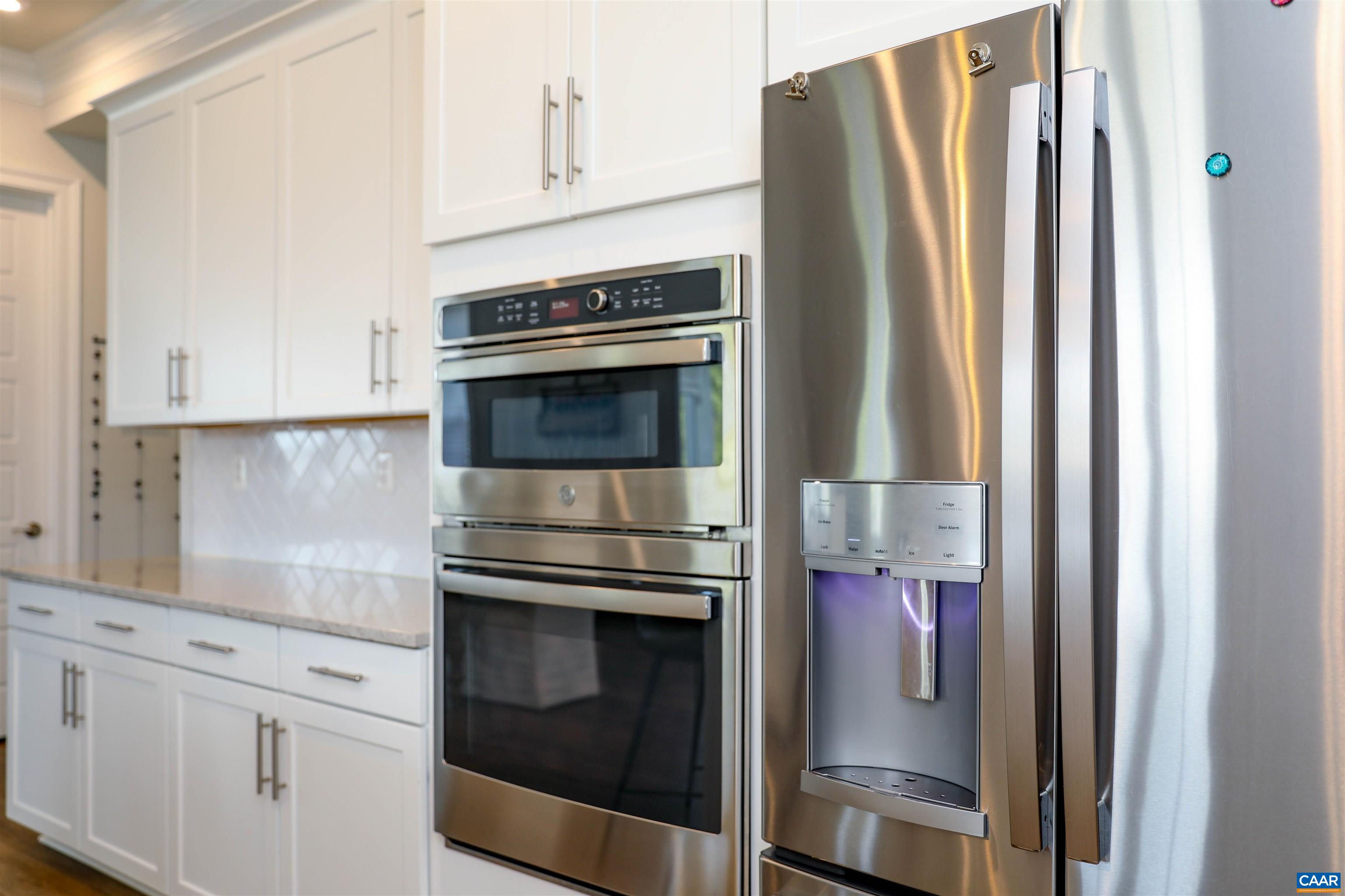2483 Ferndown Lane Keswick, VA 22947 - Photo 13 of 54 a kitchen with stainless steel appliances white cabinets and a refrigerator