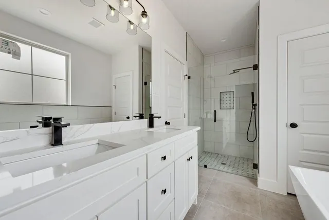 a bathroom with a double vanity sink mirror and shower