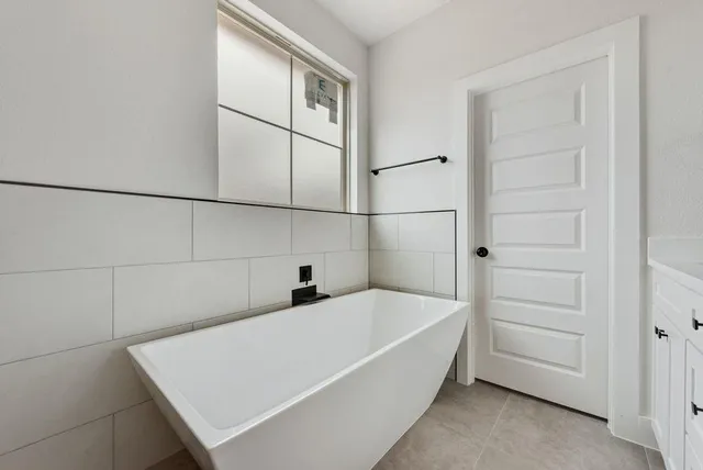 a bathroom with a tub and shower