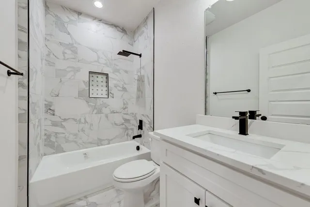 a bathroom with a sink a toilet and a bathtub