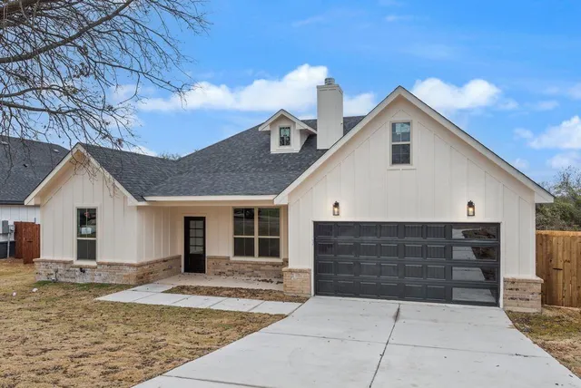 a front view of a house with garage