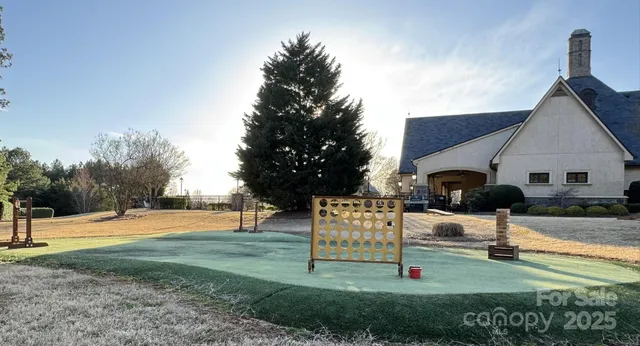 a view of a yard with trees in the background