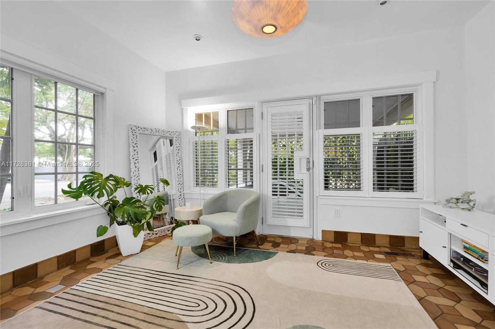 178 Northeast 45th Street Miami, FL 33137 - Photo 12 of 47 a living room filled with furniture and a potted plant