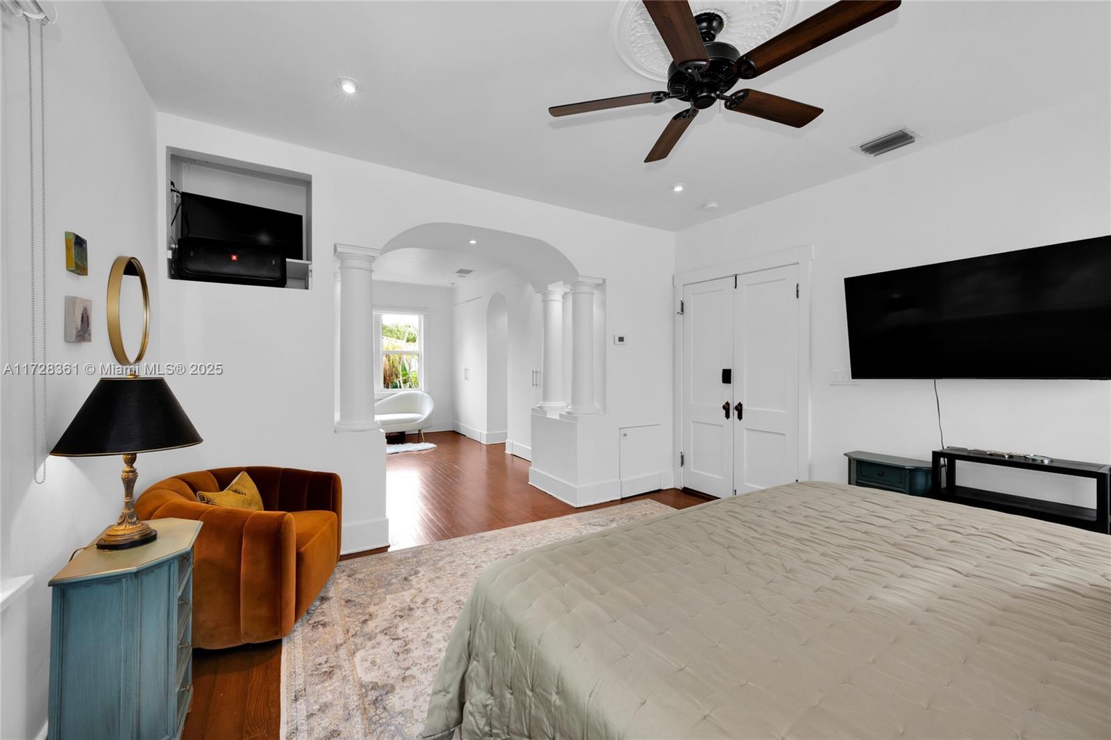 178 Northeast 45th Street Miami, FL 33137 - Photo 19 of 47 a bedroom with a bed and a flat tv screen on wall