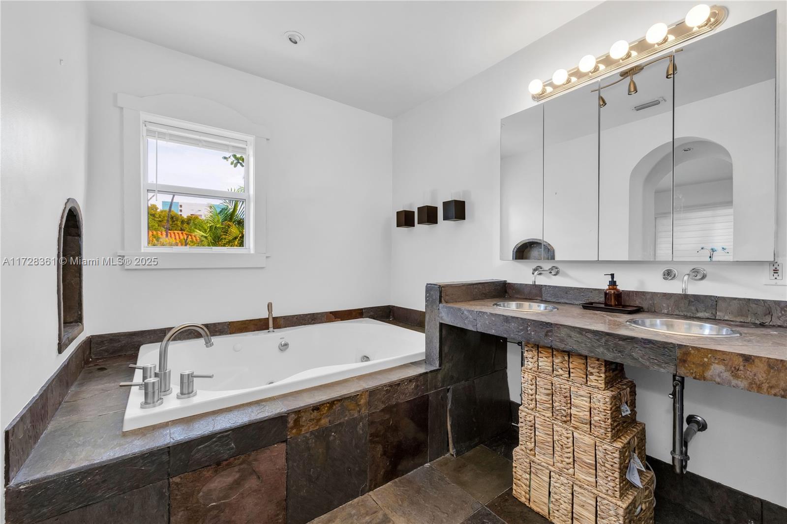 178 Northeast 45th Street Miami, FL 33137 - Photo 24 of 47 a bathroom with a tub sink and mirror