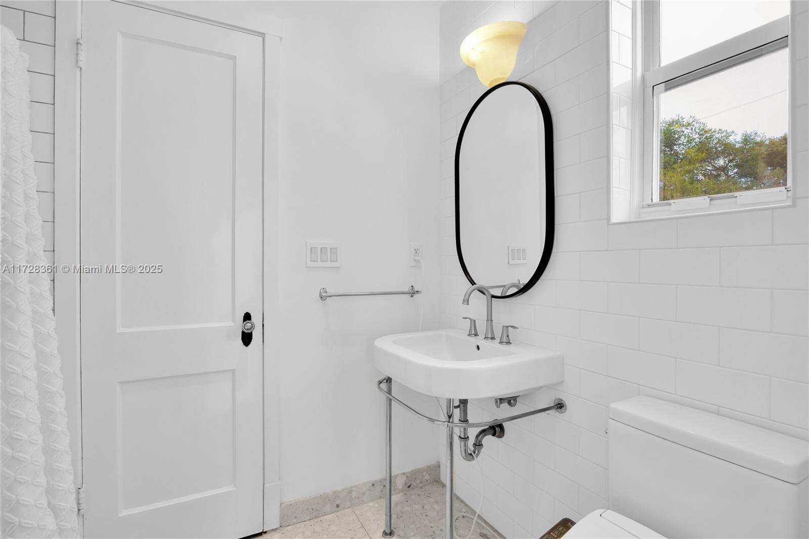 178 Northeast 45th Street Miami, FL 33137 - Photo 28 of 47 a bathroom with a sink and a mirror